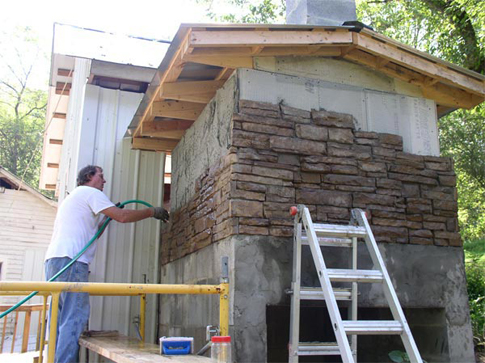 outside rock wall being hosed off